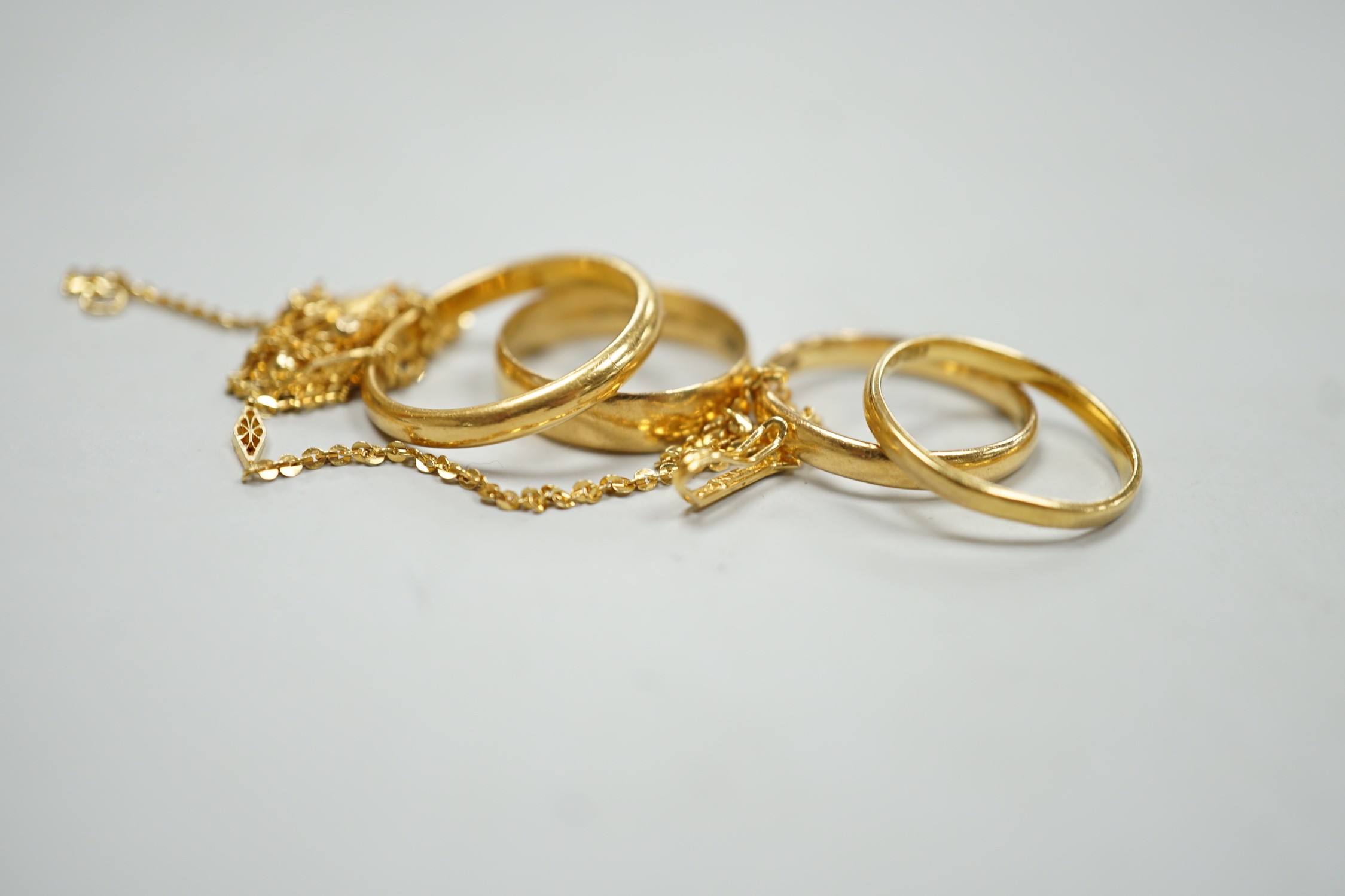 Four assorted 22ct gold wedding bands, including Birmingham, 1913, size P/Q and a 22k fine link chain, 46cm, gross 13.1 grams.